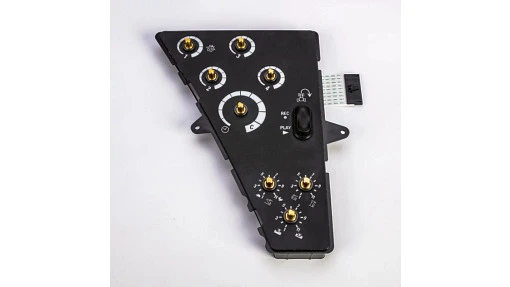 Control panel for New Holland tractor operator station. Houses switches, displays, and controls for equipment operation.