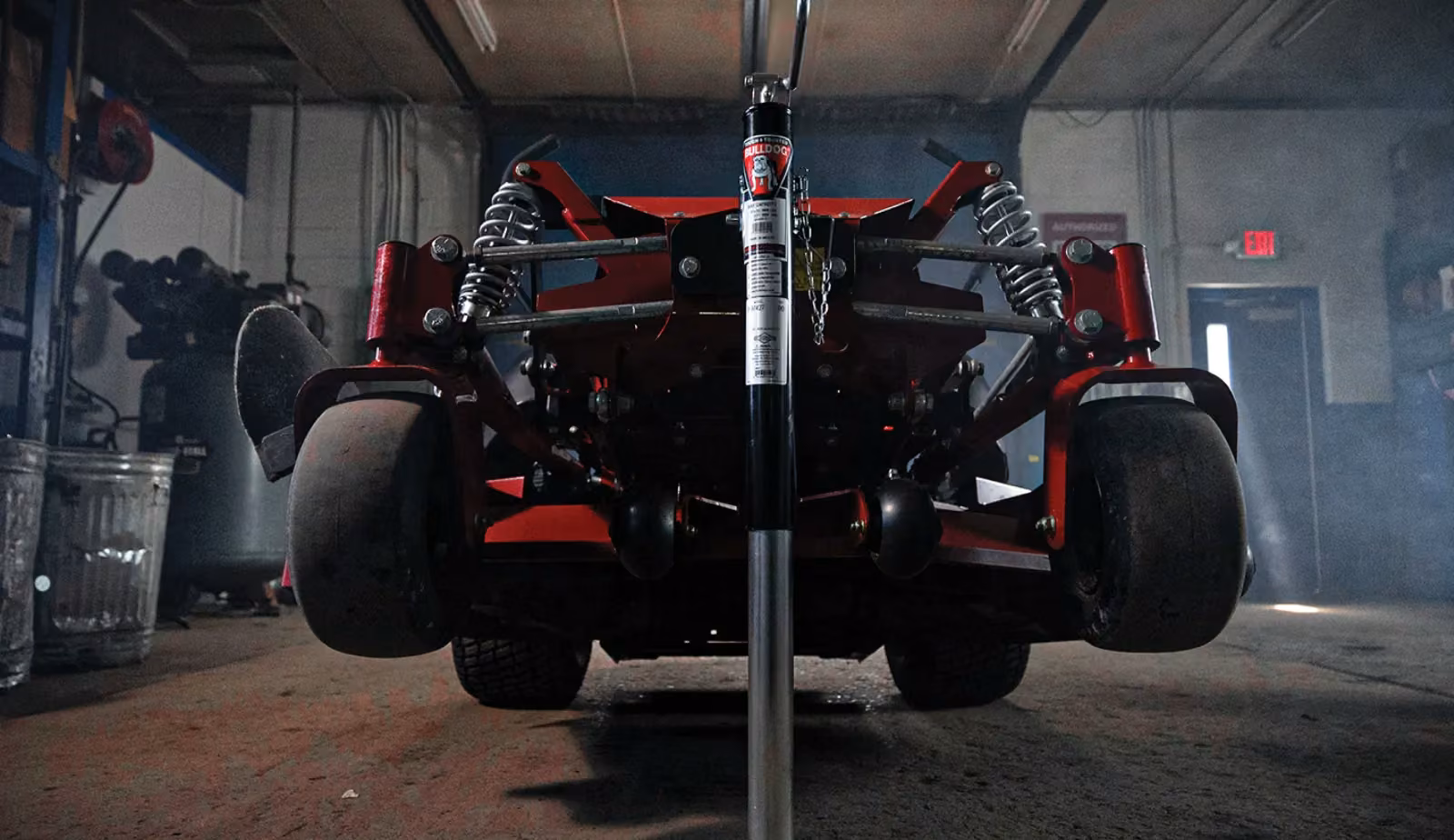 Underside of a Ferris mower deck raised on a service jack
