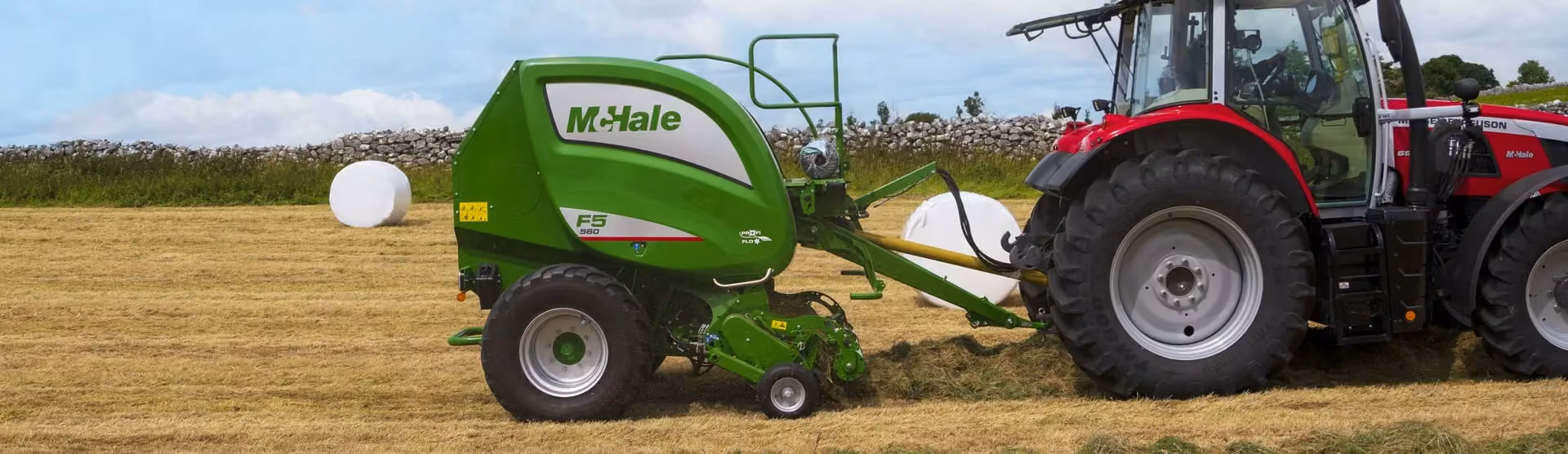 McHale F5 560 fixed-chamber round baler making a bale behind a Massey Ferguson tractor