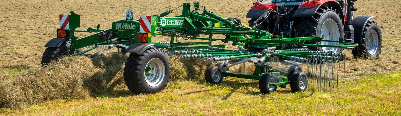 McHale R68-78 rake tedding hay behind a tractor