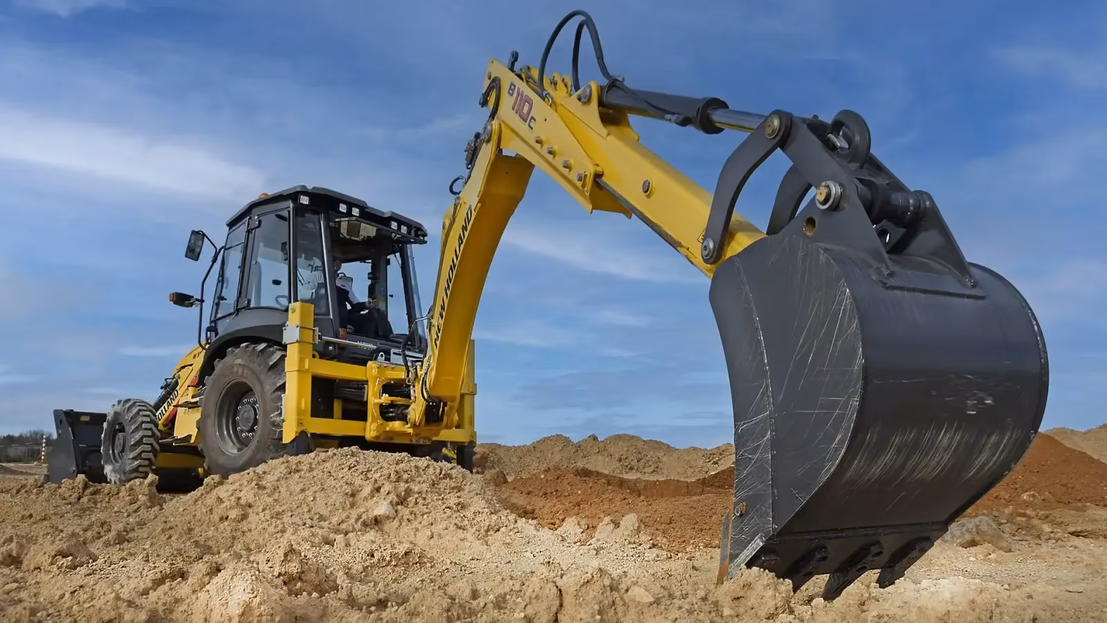New Holland backhoe loader excavating