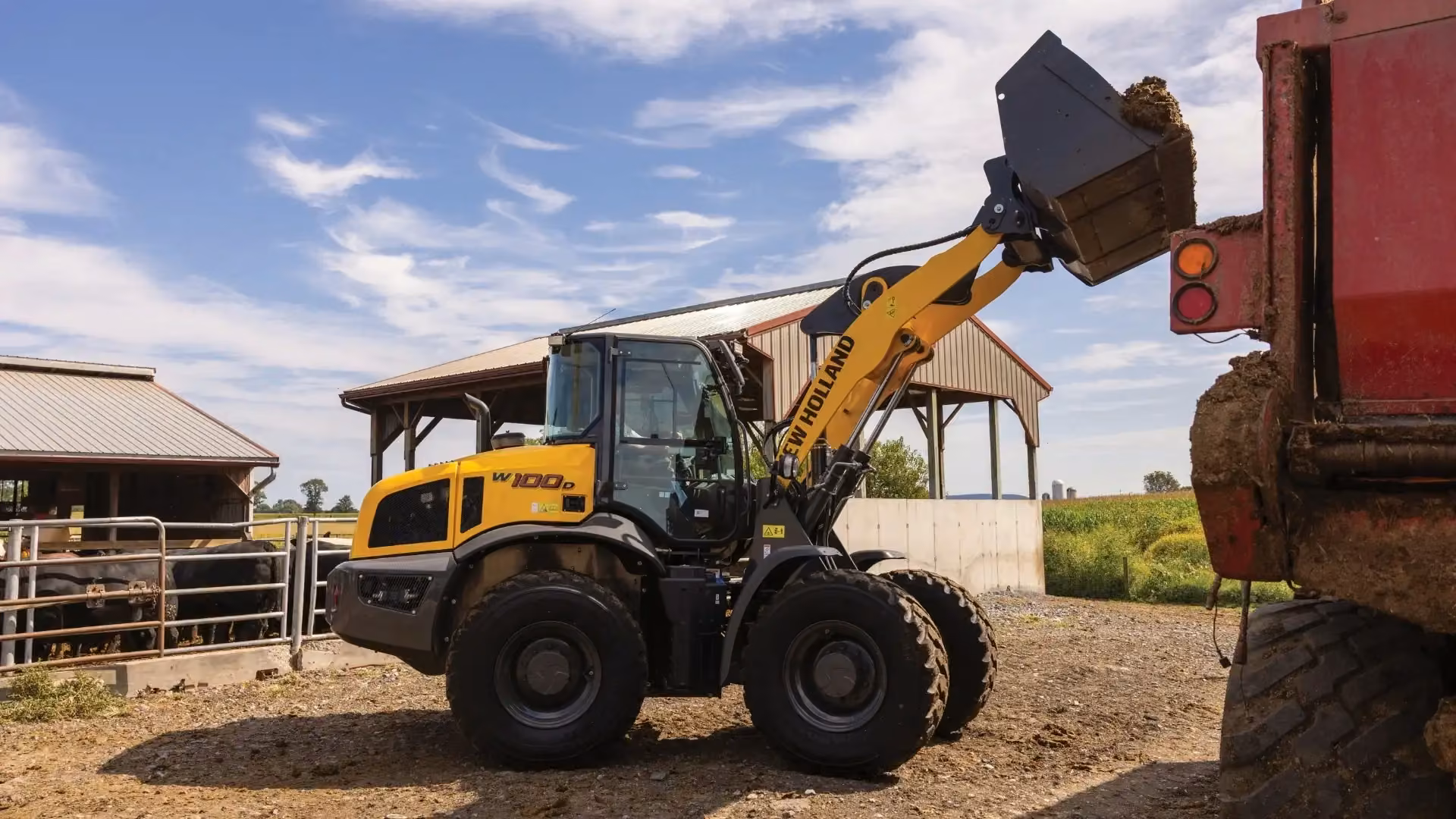 New Holland compact wheel loader lifting a full bucket
