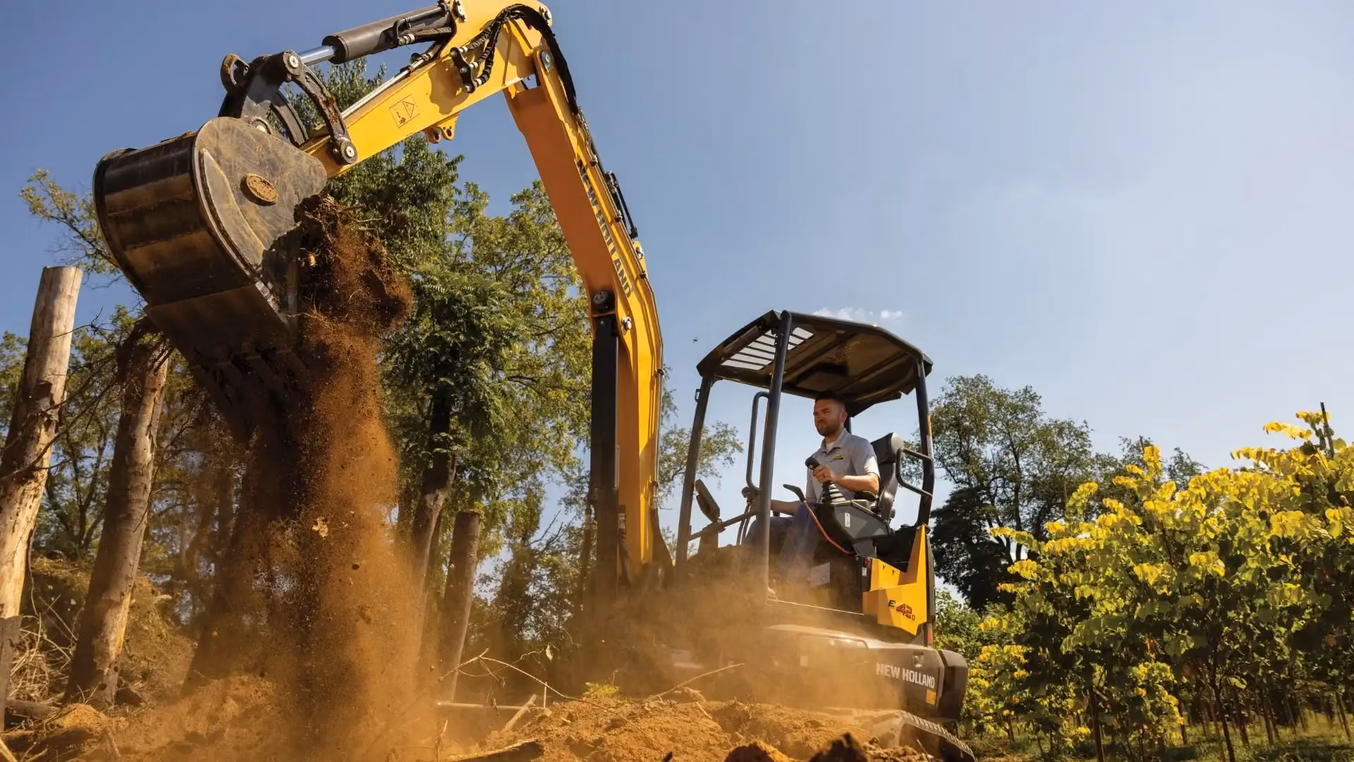 New Holland mini excavator digging a trench