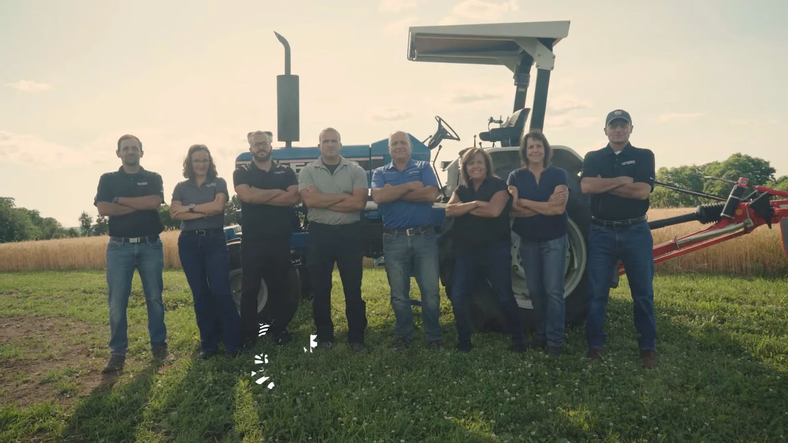The Clinton Tractor team in front of a tractor
